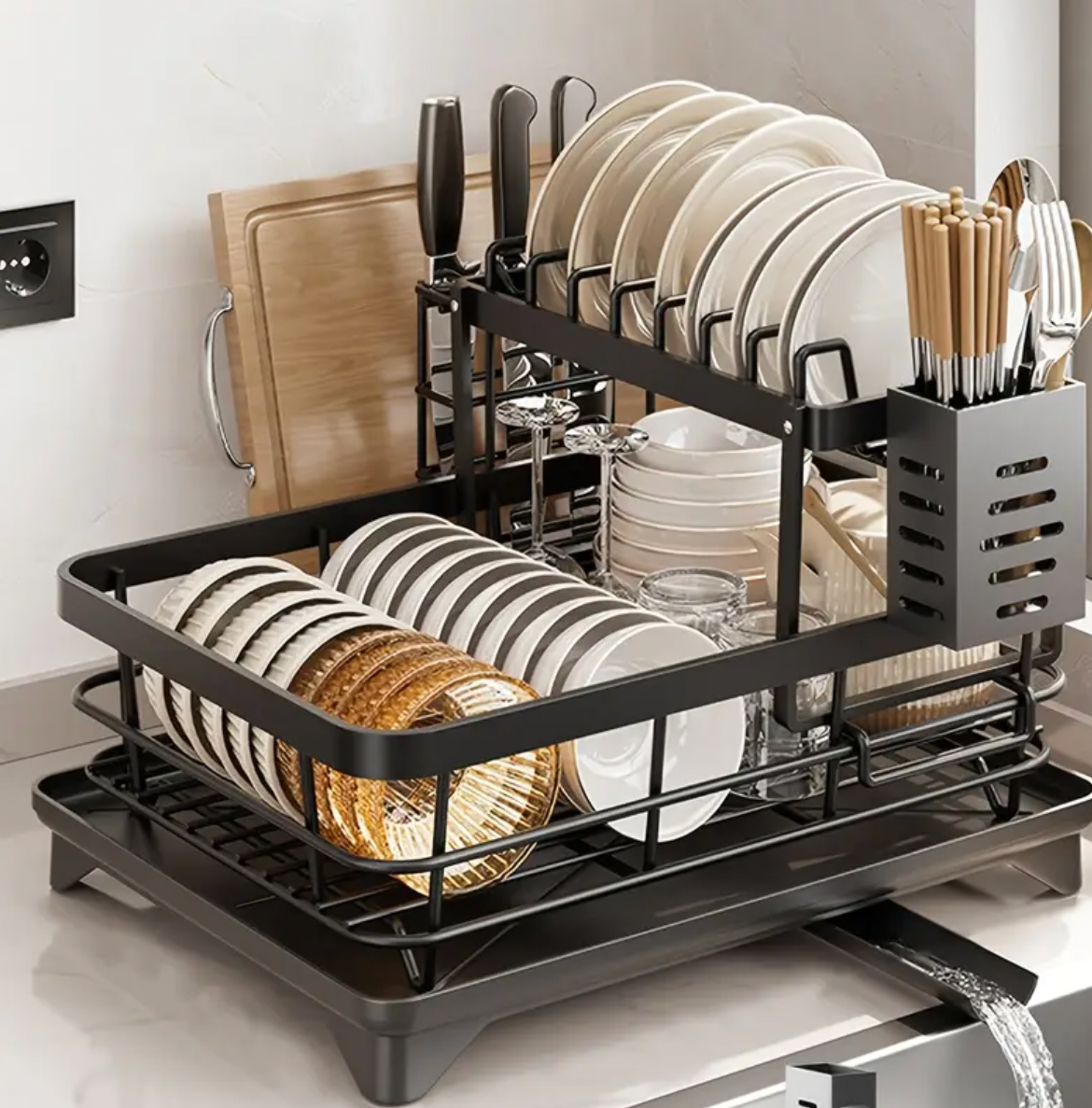 Dish rack with plates and utensils on a kitchen counter