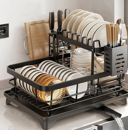 Dish rack with plates and utensils on a kitchen counter